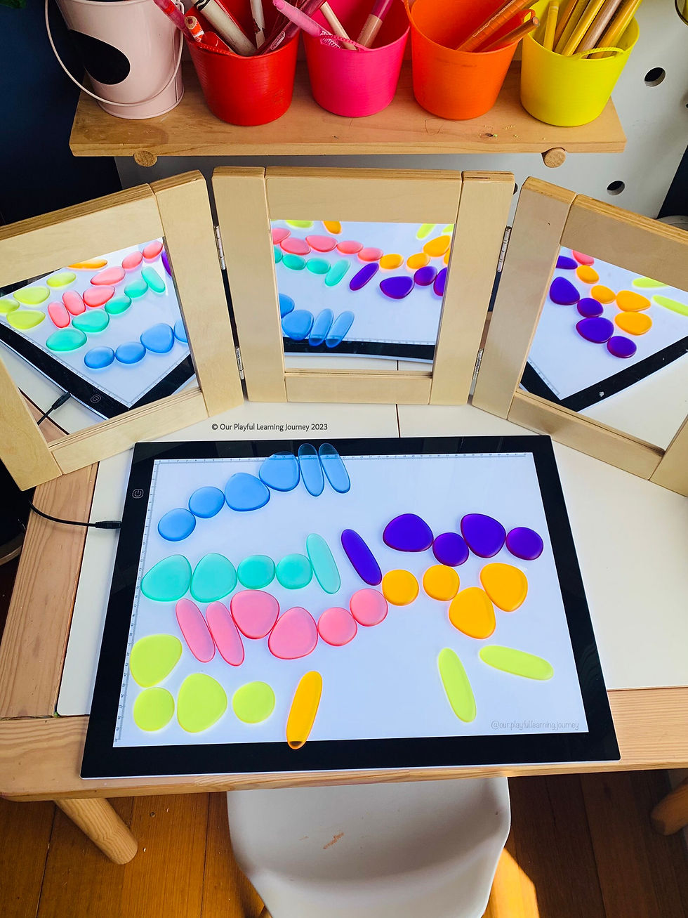 Light panel play idea for kids - exploring translucent pebbles on the light panel