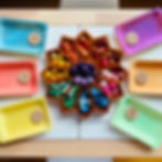 Star shaped tray filled with colourful Grapat mandala loose parts and number sorting trays on a table