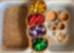 Sensory tray filled with chickpeas, bowls, scoops and tray of Grapat mandala pieces
