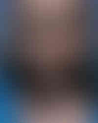 a close up of a woman 's face with a blue shirt on