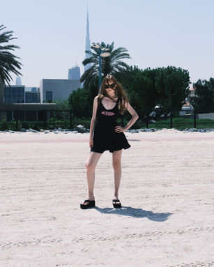 a woman wearing a black dress that says ' swimsuit ' on it