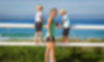 Bek Nutter, naturopath, and her children leaning on the fence overlooking the beach in Newcastle NSW