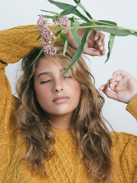A woman with eyes closed thinking