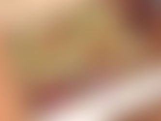 Eye-level view of a neatly arranged sandwich box meal with sides and a drink on a wooden table