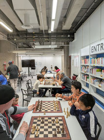 Young players concentrate during the ChessMates chess workshop at the Cité des sciences library, Paris.