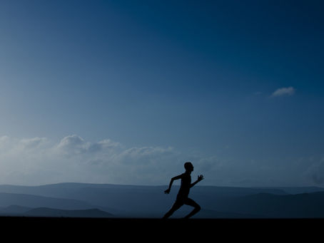 A person running with a scenic background