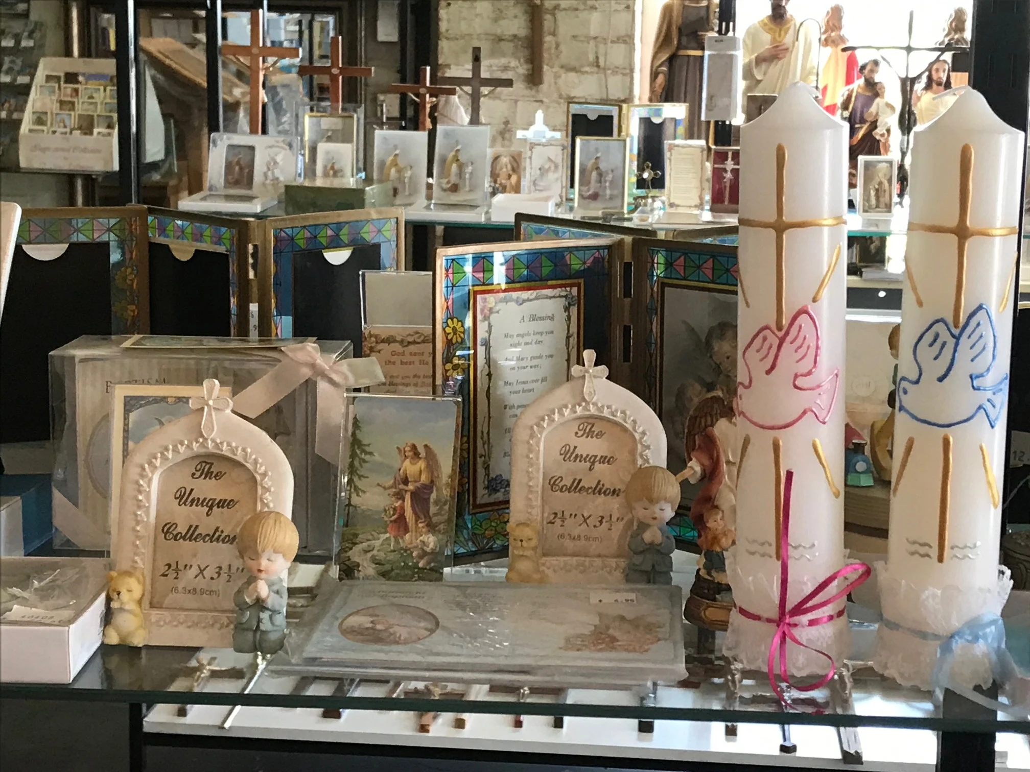 Baptism candles and keepsakes displayed in the Ashfield store