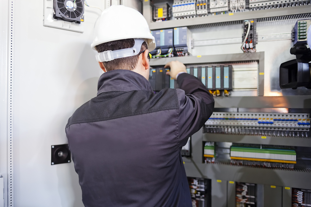 DM Automation team commissioning a UL 508A certified control panel for industrial automation.