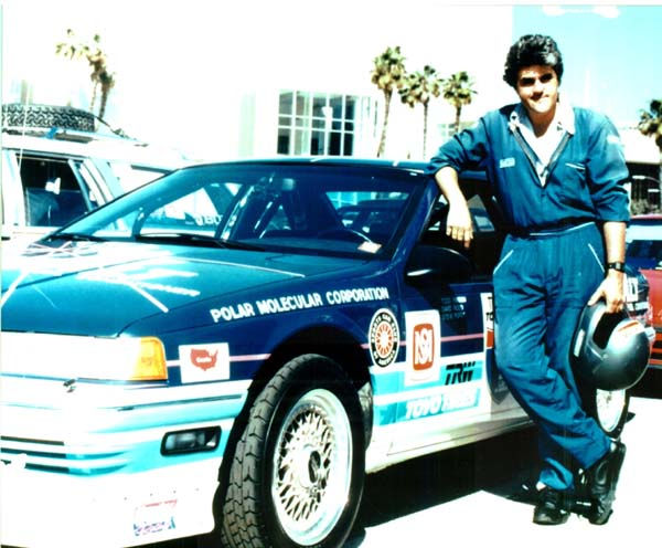 Jay Lenno standing next to Racecar