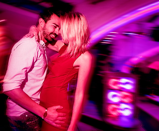 Image of a man and woman dancing in a nightclub to represent the Dating section of the Fox & Muse app.
