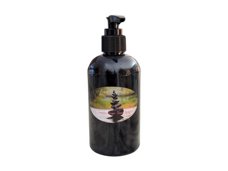 A black bottle with a pump dispenser labeled "Edie Jean's Soothing Massage Oil" set against a white background. The label lists various ingredients.