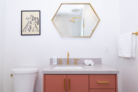 Furnished bathroom with hexagon mirror