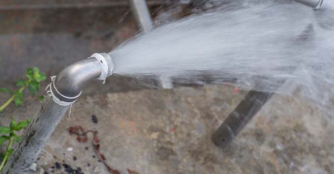 Burst pipe leaking water wide