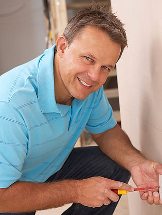 Pakenham electrician holding screw driver smiling at camera