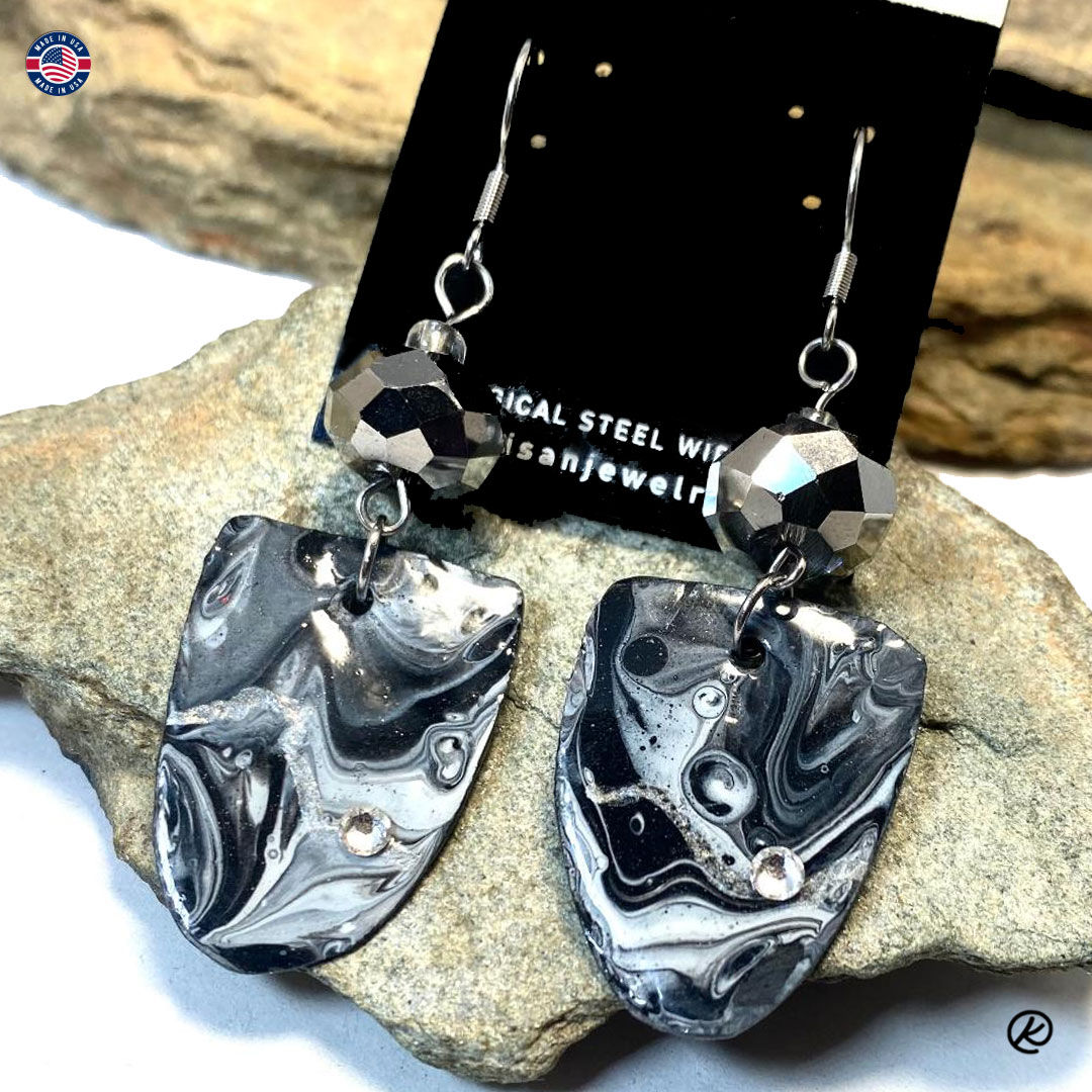 Larger black and white earrings on slate