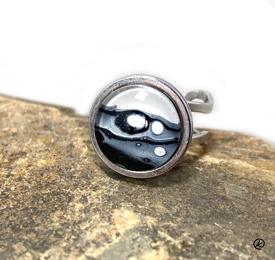 Small stainless steel ring with black and white poured acrylics