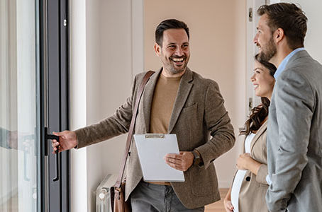 Agent showing rental property to young couple