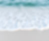 calm ocean waves coming ashore on white sandy beach.jpg