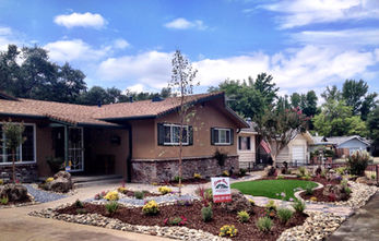 Residential home with landscaping and open sky, real estate, community, property.
