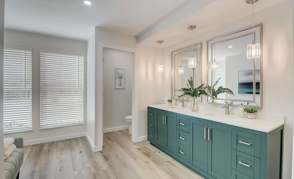 New bathroom with teal cabinet and bright lights.