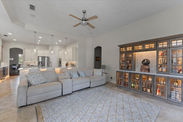 Cozy living room with a bar and lots of natural light.