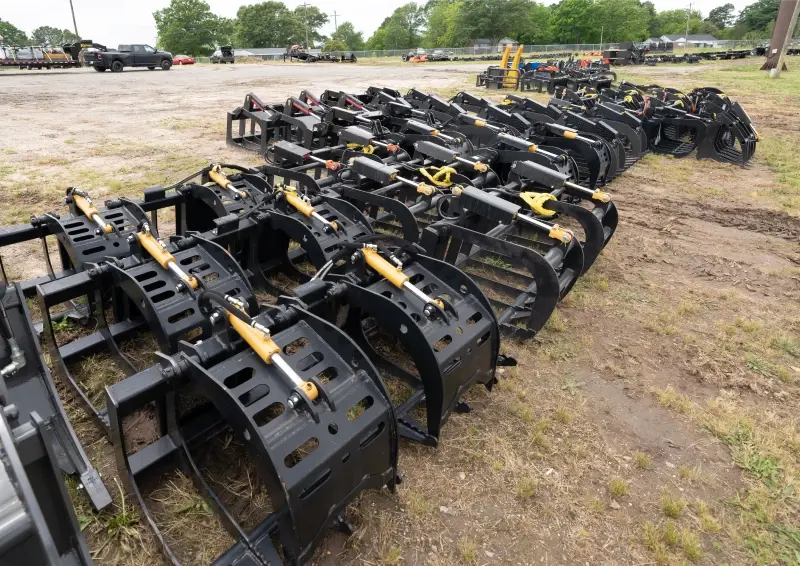 Rows of heavy equipment grapples
