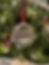 Ornament hanging, reads Grand Holland Estate, Christmas Ornament, on decorated Christmas tree background.