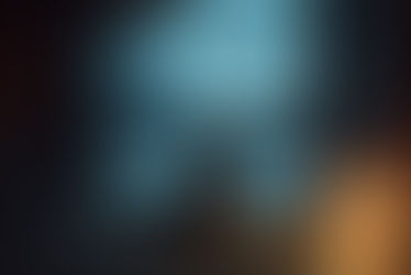 A young child wearing a chunky grey wool knit sweater sits quietly on a textured rug, facing away from the camera. They are looking out a large floor-to-ceiling window at a snowy Nordic forest during the blue twilight hours. A single warm lamp glows on the floor beside them, creating a cozy sanctuary against the cold.