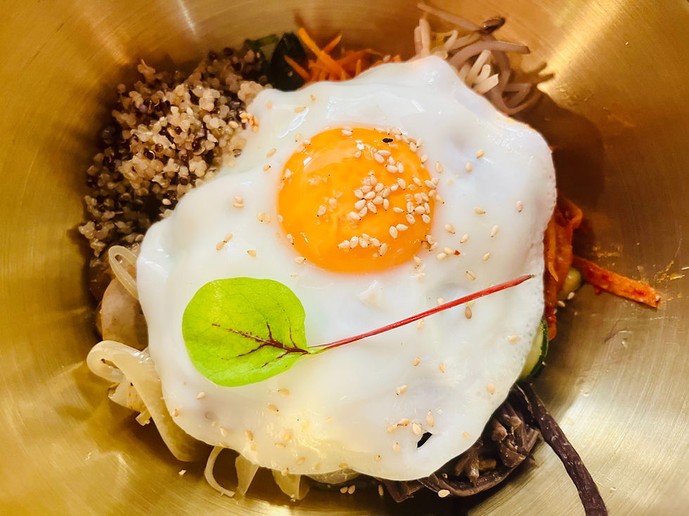 High angle view of a Korean Bibimbap bowl with colorful vegetables and egg on top