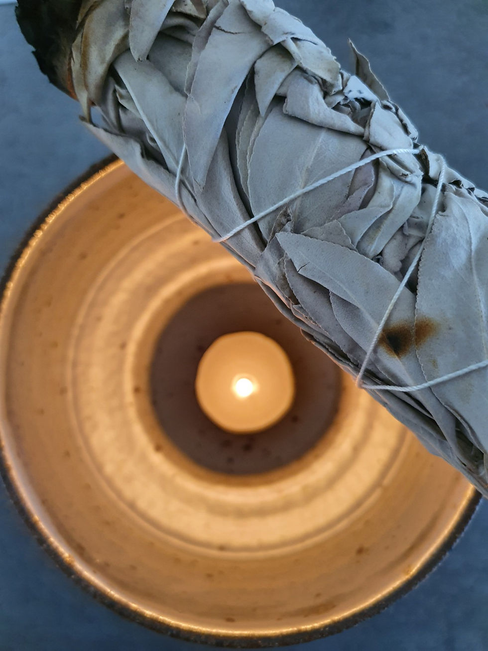 Sustainably harvested white sage smudge stick with a tea light candle