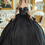 Thumbnail: Elegant woman in black Jovani 38378 Asymmetrical Corset Prom Dress posing indoors with opulent decor.