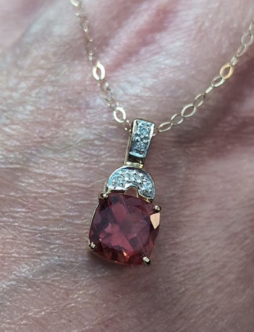 Thumbnail: yellow gold pendant set with a cushion cut red andesine gemstone and small round diamonds at the top