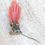 Thumbnail: A Victorian brooch of a red hand with gold bracelets