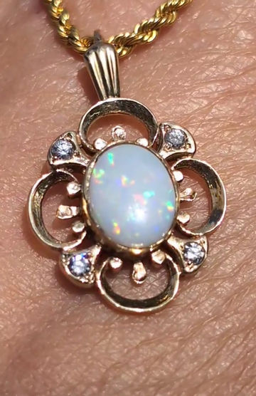 Thumbnail: vintage yellow gold flower shaped pendant set with precious white opal and four diamonds