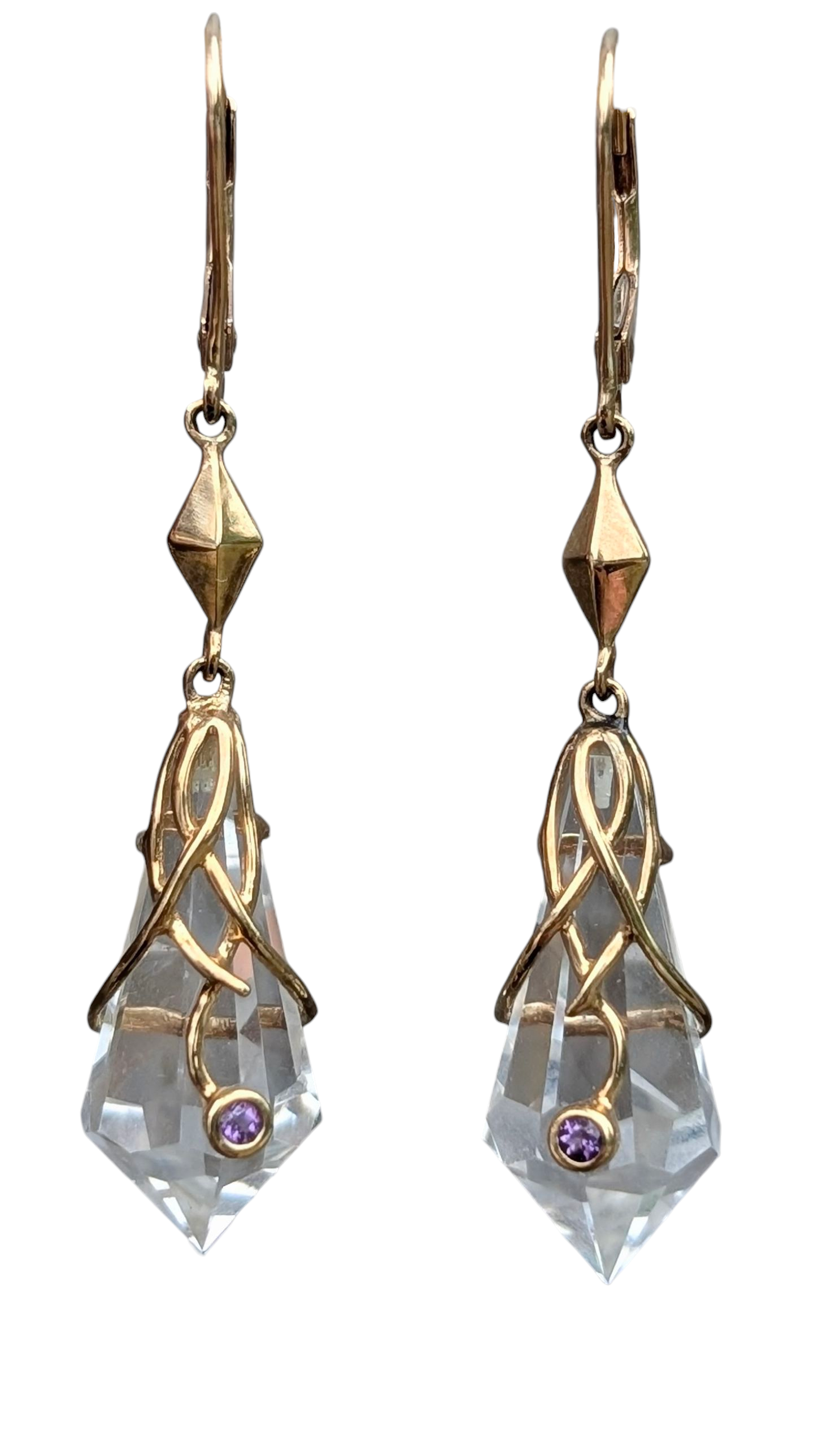 large earrings with beautifully cut rock crystals, each with a small round bezel set amethyst intertwined into yellow gold