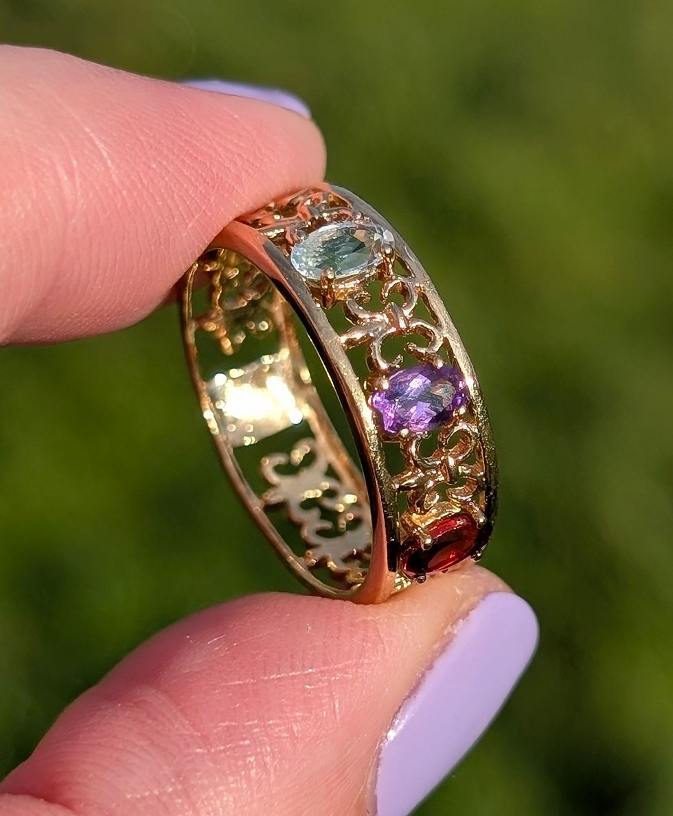 Thumbnail: vintage yellow gold band with open work design and oval red garnet, amethyst and blue topaz set into it