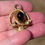 Thumbnail: victorian ornate gold pendant with garnet cabochon