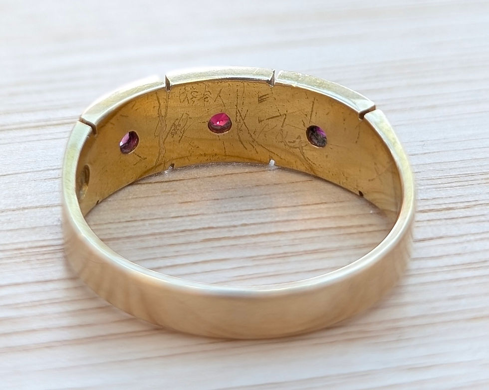 Thumbnail: victorian yellow gold band with three panels of seed pearls surrounding a ruby