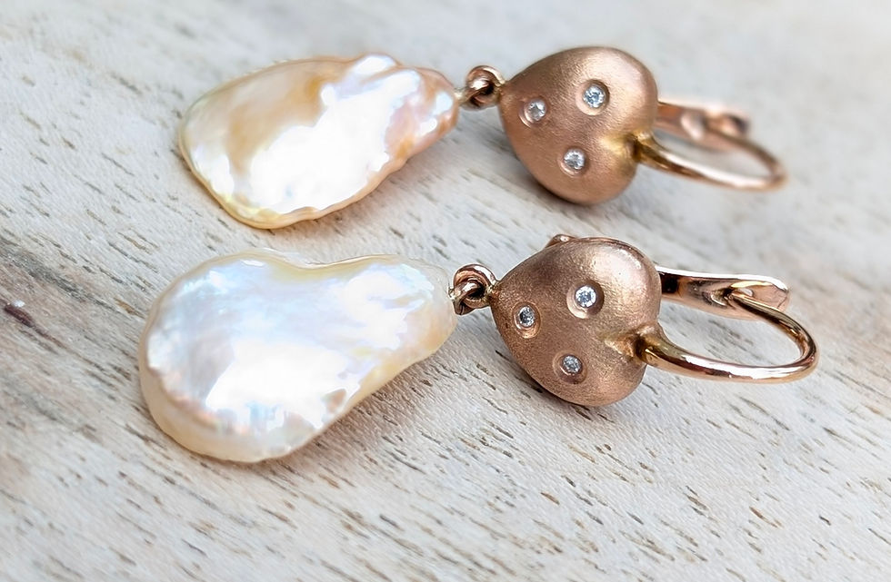 Thumbnail: hook earrings with pear shaped pearls dangling from brushed rose gold heart set with 3 small round diamonds