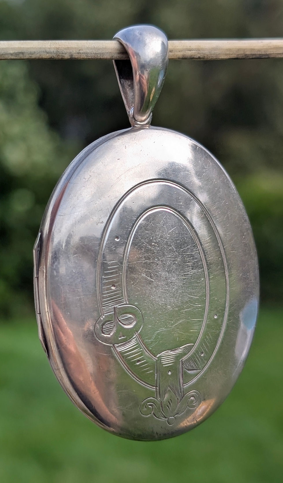 Thumbnail: a Large Victorian oval shaped silver Locket engraved with buckle or garter design