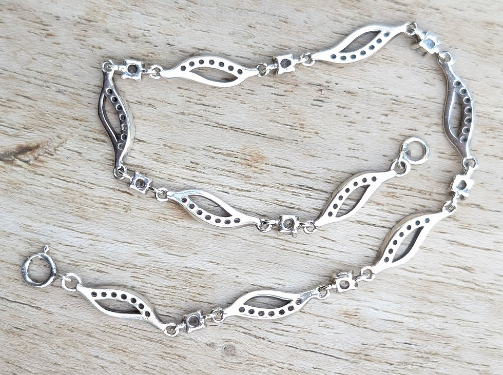 Thumbnail: a this wavy silver articulated bracelet with colourless sparkly stones