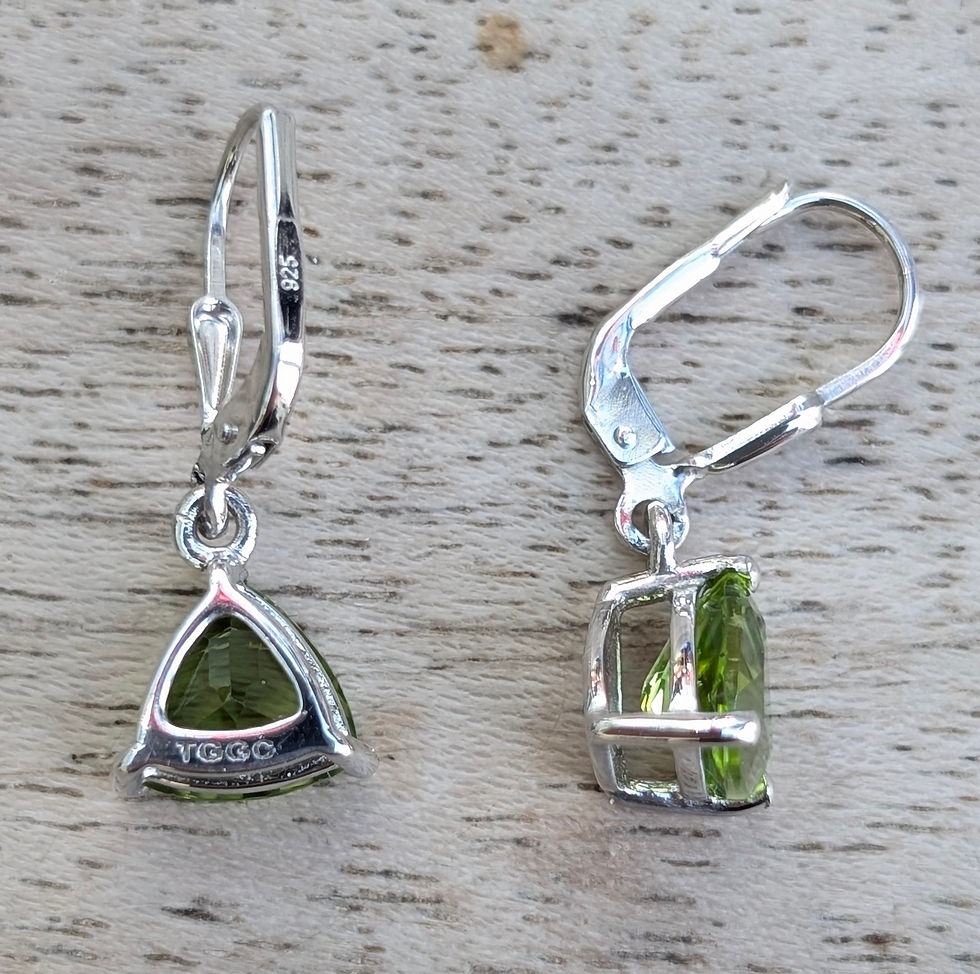 Thumbnail: Silver earrings, with trillion shaped vivid green peridot gemstones dangle from silver hooks