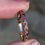 Thumbnail: vintage yellow gold half eternity ring set with rubies