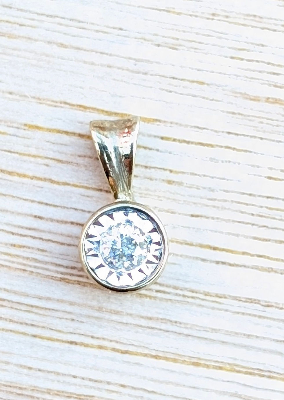 Thumbnail: A small round vintage gold pendant set with a round diamond