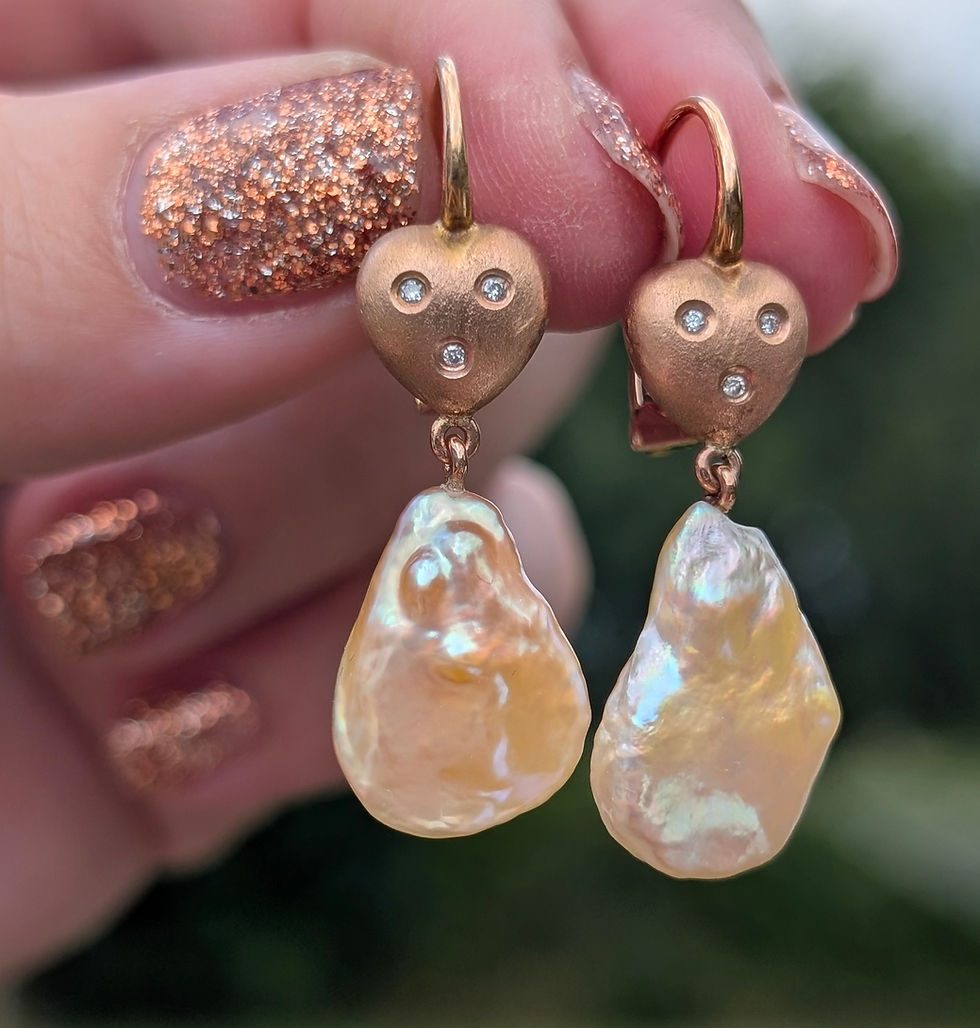 Thumbnail: hook earrings with pear shaped pearls dangling from brushed rose gold heart set with 3 small round diamonds