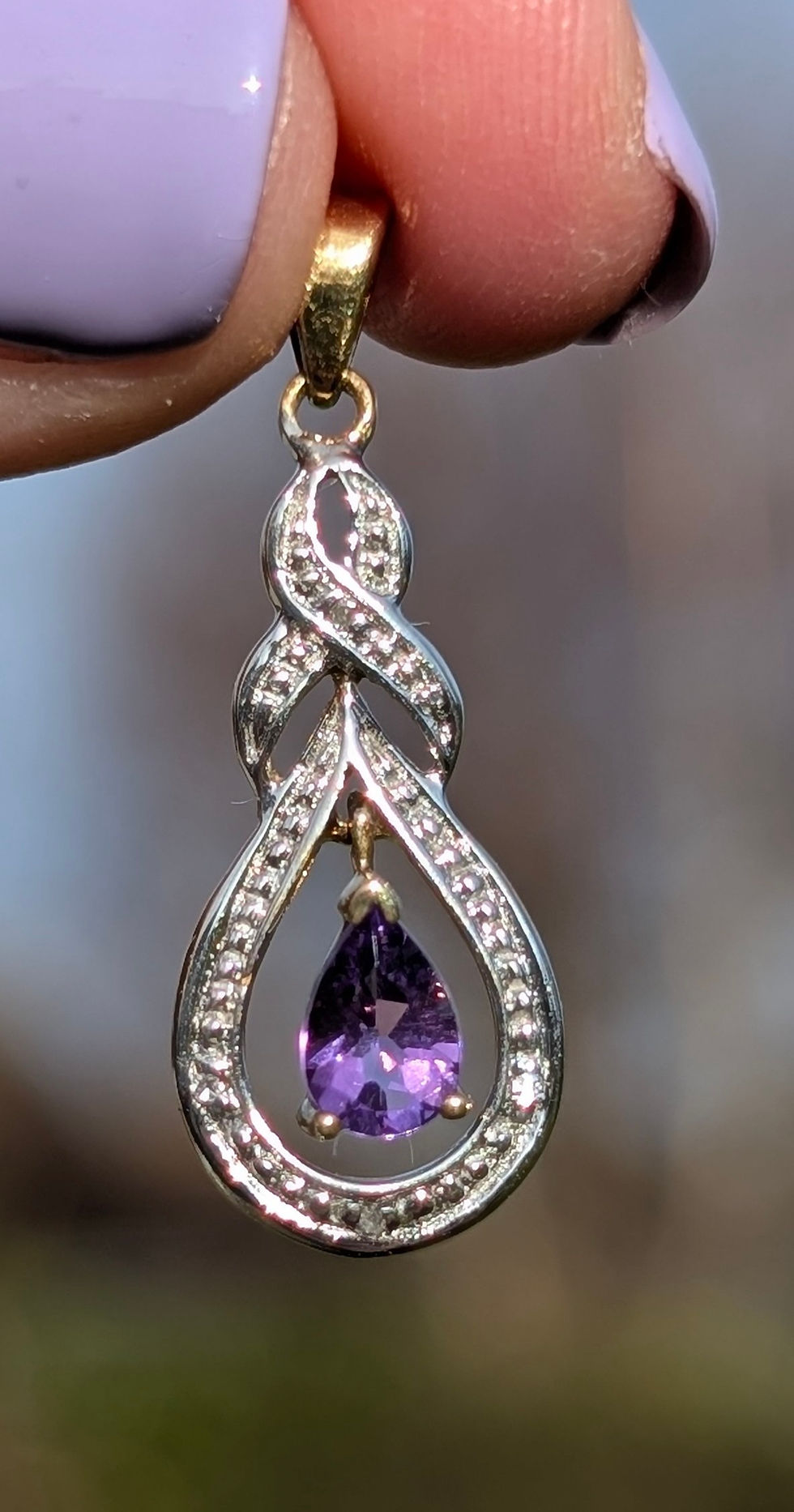 Thumbnail: Vintage yellow and white gold infinity twist tear drop shape pendant with pear shape amethyst and diamonds