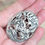 Thumbnail: A large oval silver brooch with floral design by designer Steve Stamas