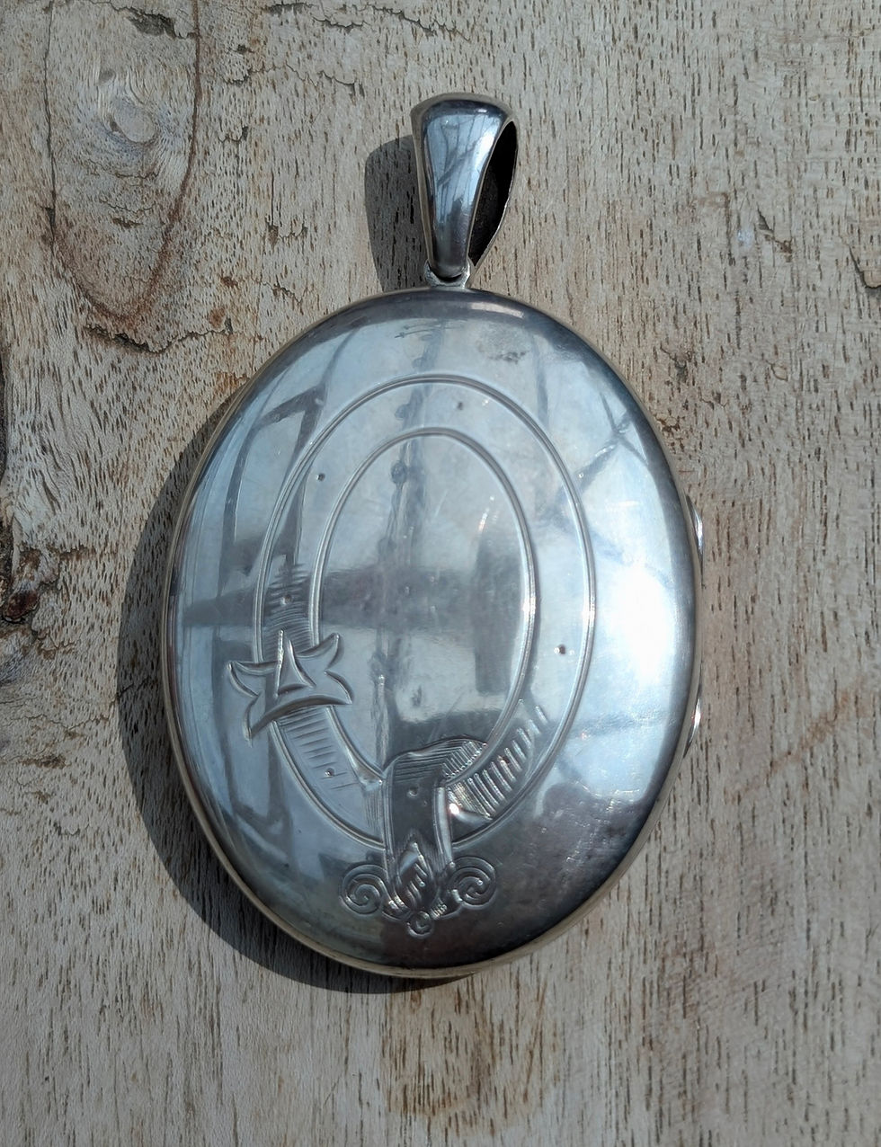 Thumbnail: a Large Victorian oval shaped silver Locket engraved with buckle or garter design