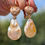 Thumbnail: hook earrings with pear shaped pearls dangling from brushed rose gold heart set with 3 small round diamonds