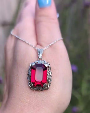Thumbnail: Antique ornate silver pendant set with a vivid emerald cut paste stone